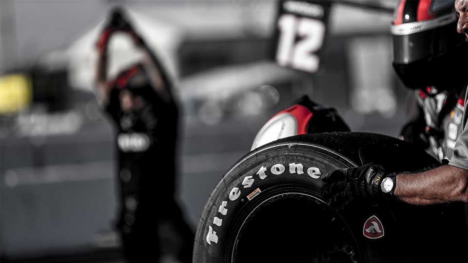 A technician waits to change a Firestone Tire